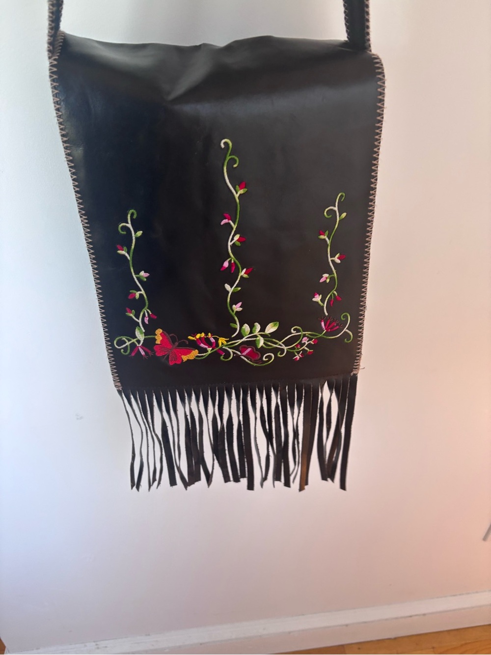 Wilsons Leather Black Crossbody Bag with Floral Embroidery and Fringe